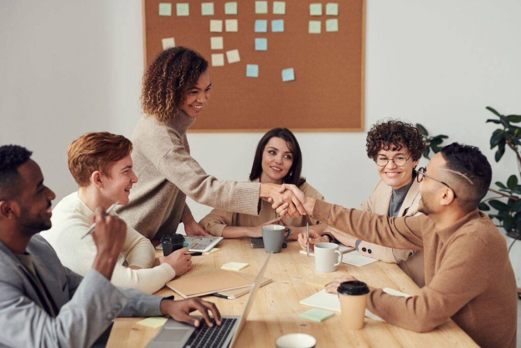 staffing solutions team shaking hands after a successful hiring meeting